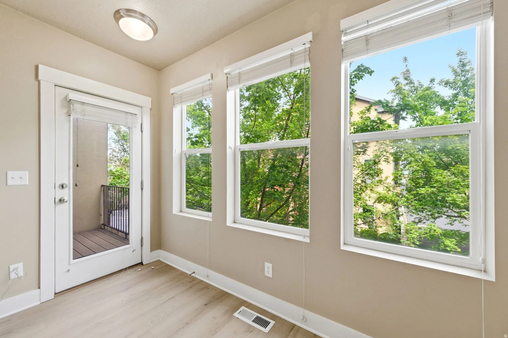 Doorway featuring baseboards and wood finished floors