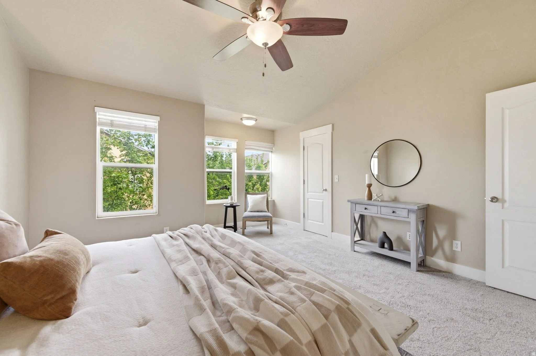 Bedroom with lofted ceiling, carpet flooring, and ceiling fan