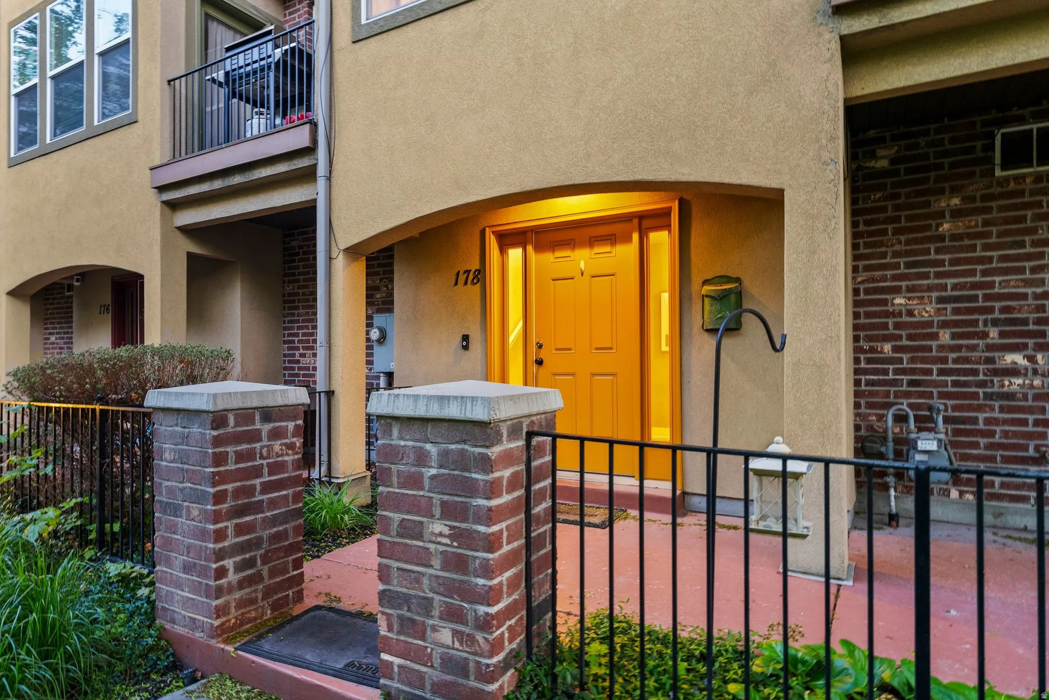 Entrance to property featuring stucco siding and brick siding