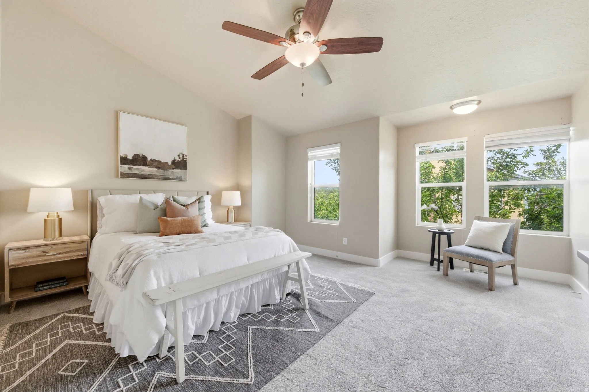 Carpeted bedroom featuring ceiling fan and lofted ceiling