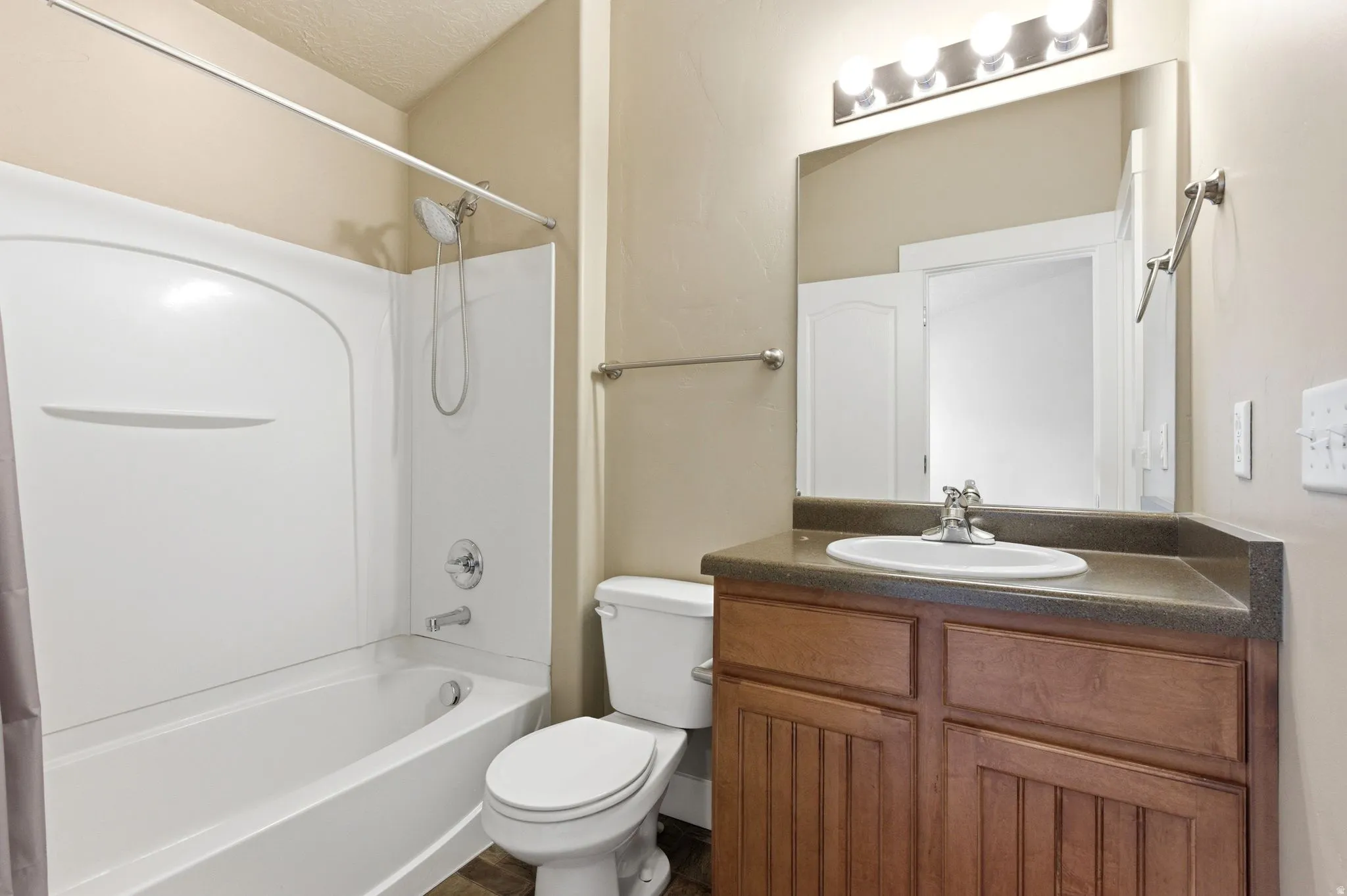Full bathroom featuring vanity and shower / washtub combination