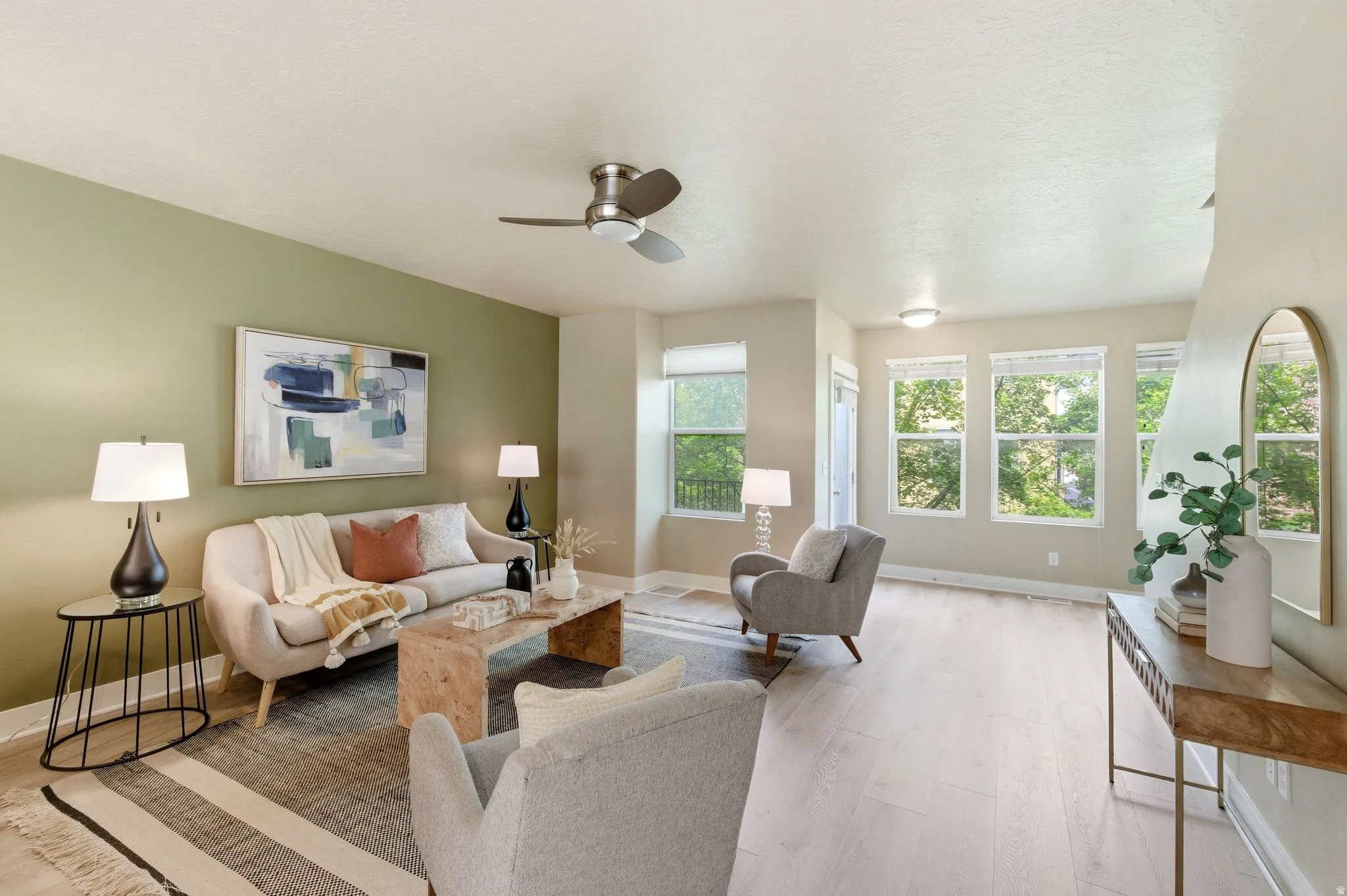 Living room featuring light wood finished floors and a ceiling fan