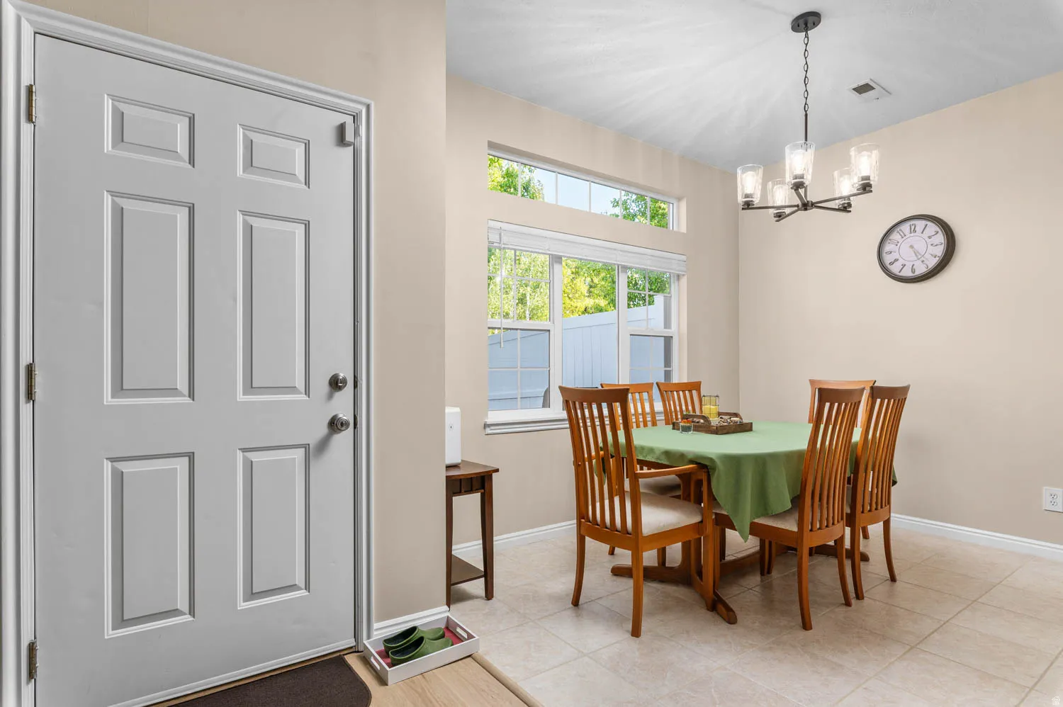 Dining area featuring a chandelier and light tile patterned flooring