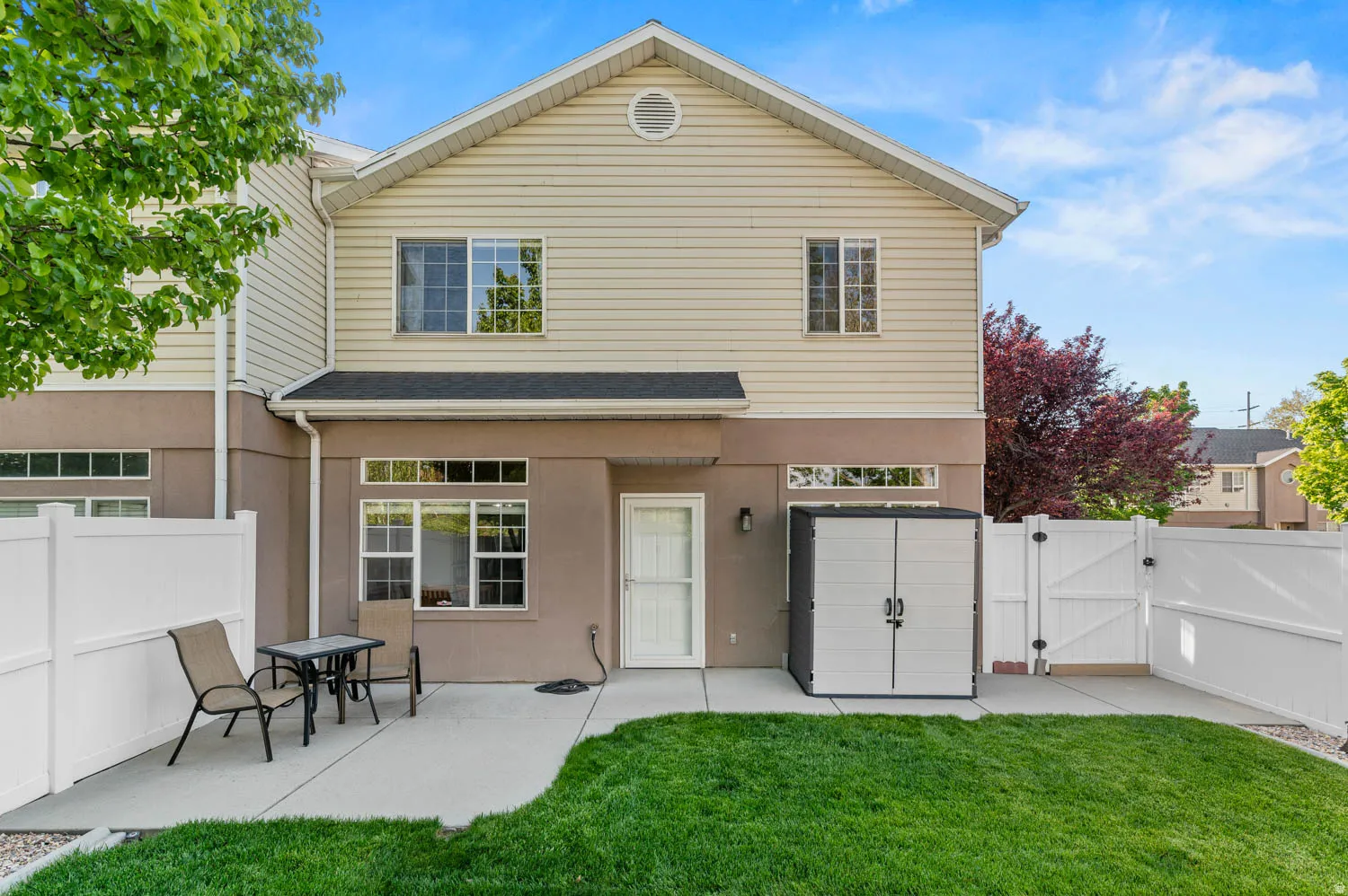 Rear view of house with a gate and a fenced backyard