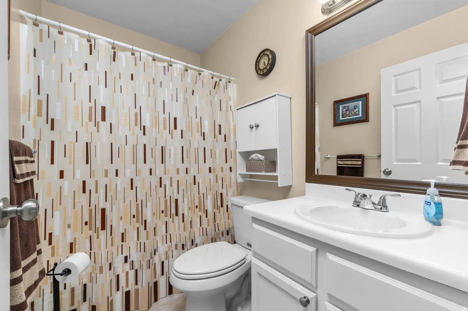 Bathroom featuring vanity and curtained shower