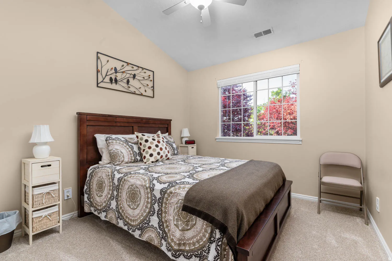 Bedroom with lofted ceiling, light carpet, and ceiling fan