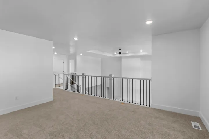 Unfurnished room featuring recessed lighting, a tray ceiling, and carpet floors