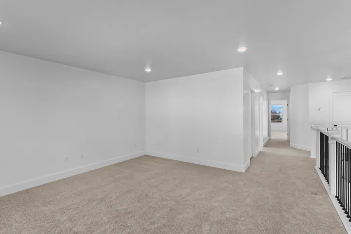 Spare room featuring light carpet and recessed lighting