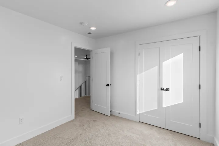 Unfurnished bedroom with light carpet, recessed lighting, and a closet
