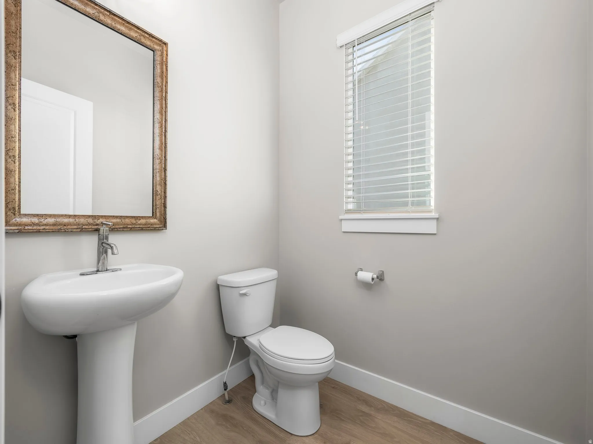 Bathroom with toilet and light wood-style floors