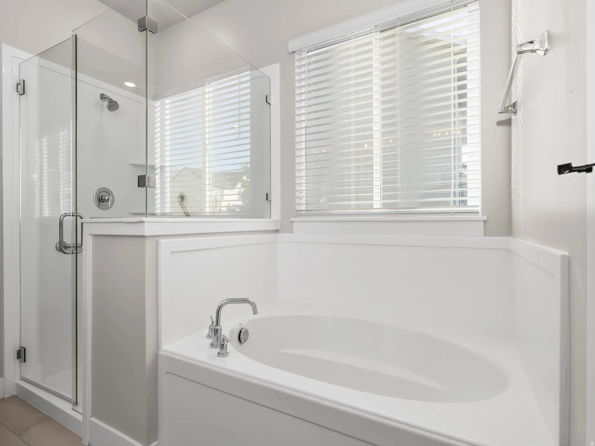 Full bathroom featuring a stall shower and a garden tub