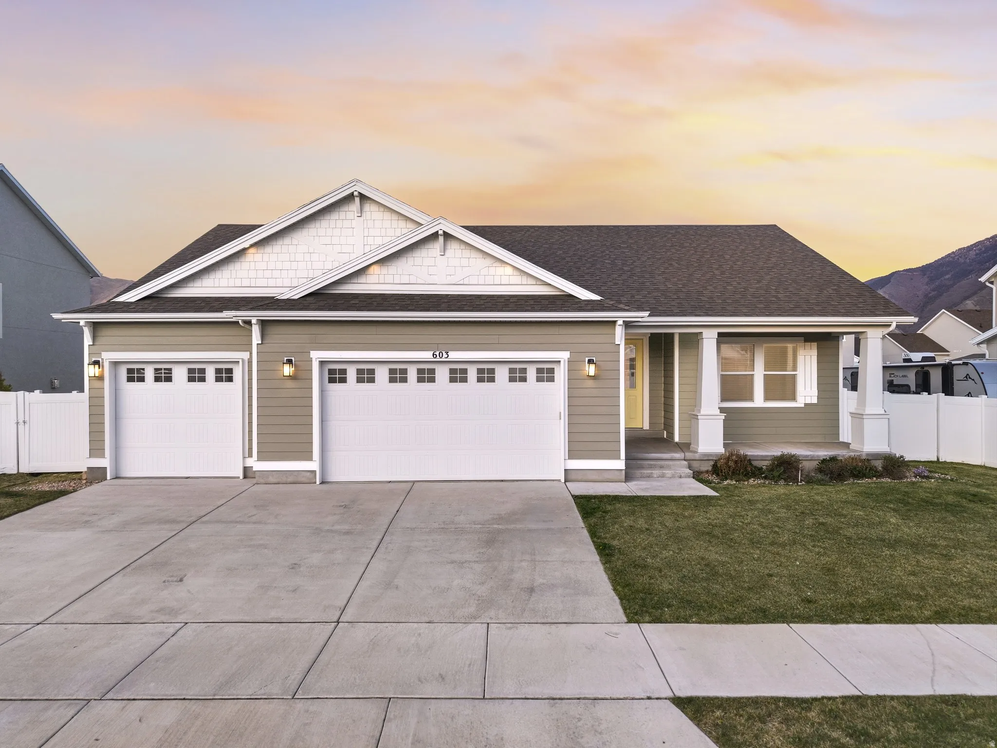 Craftsman inspired home with an attached garage, covered porch, a shingled roof, and concrete driveway