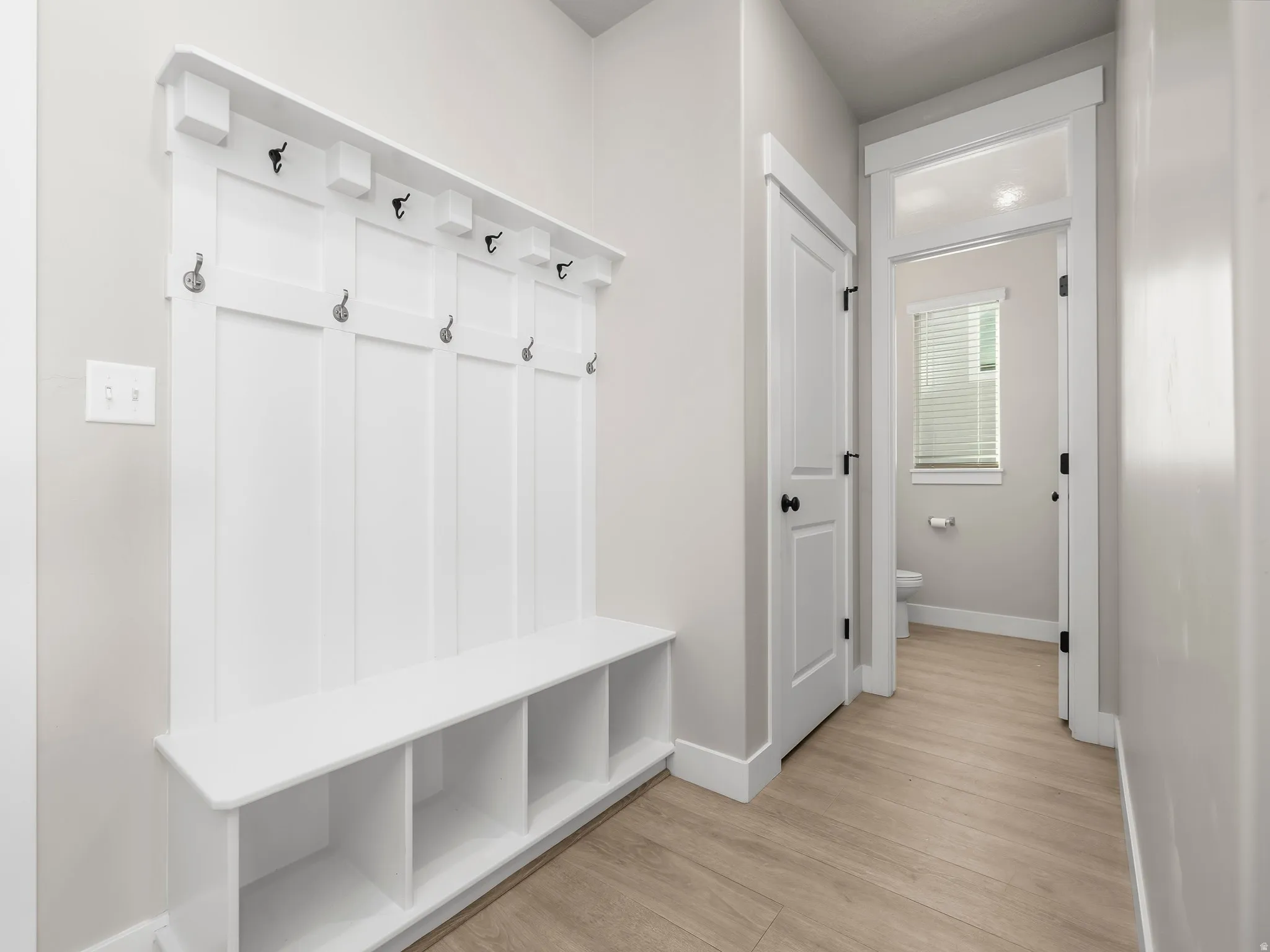 Mudroom featuring baseboards and light wood-type flooring
