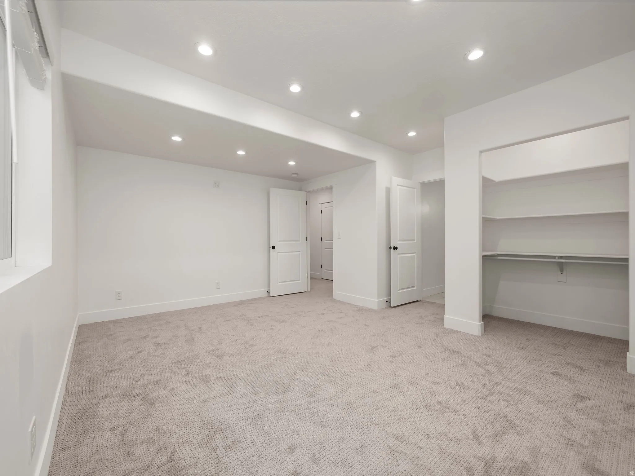 Unfurnished bedroom with recessed lighting and light colored carpet