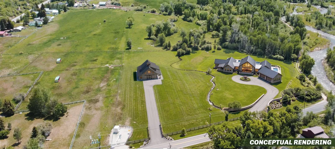 Expansive property featuring two distinct structures, a winding paved driveway, and manicured lawns