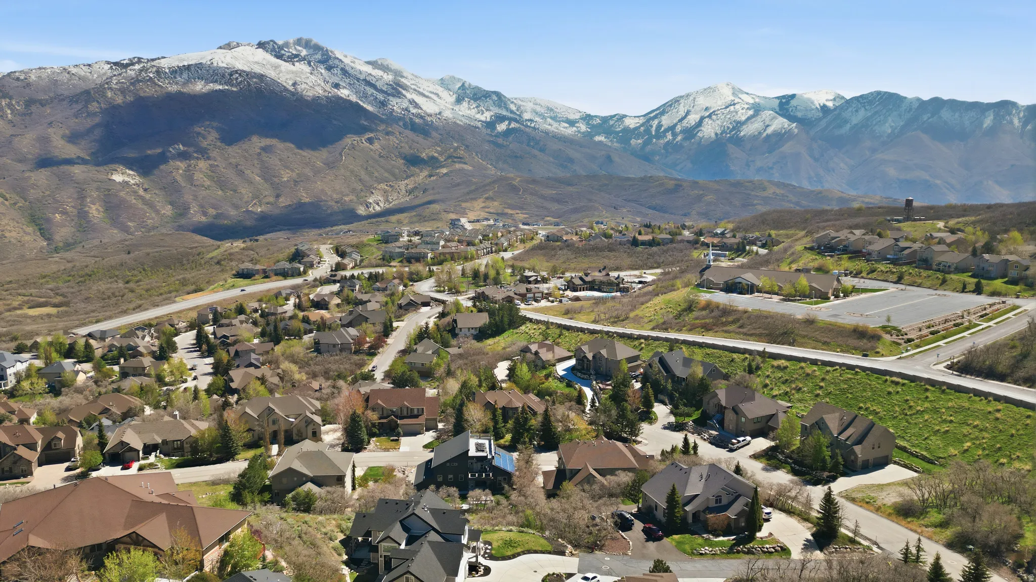 Aerial perspective of suburban area with a mountain backdrop