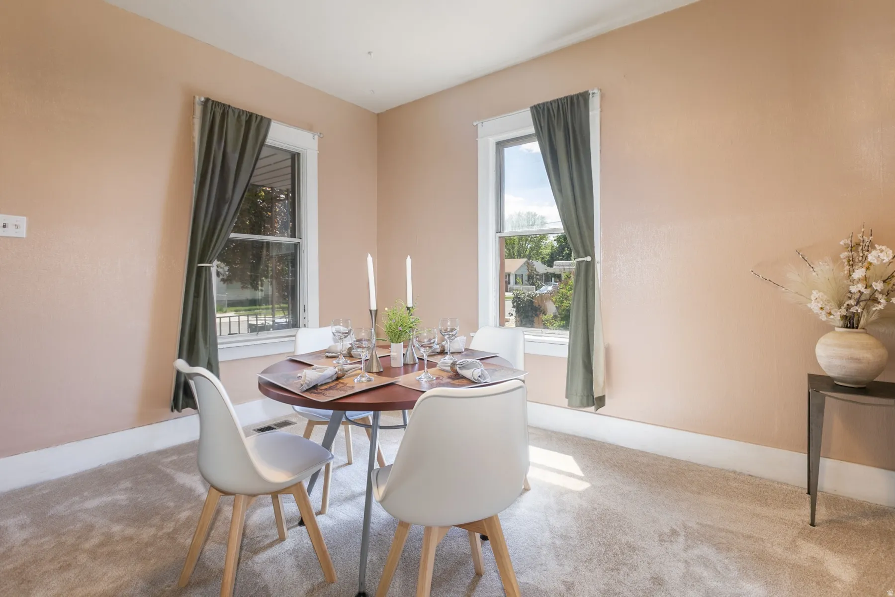 Carpeted dining space featuring baseboards