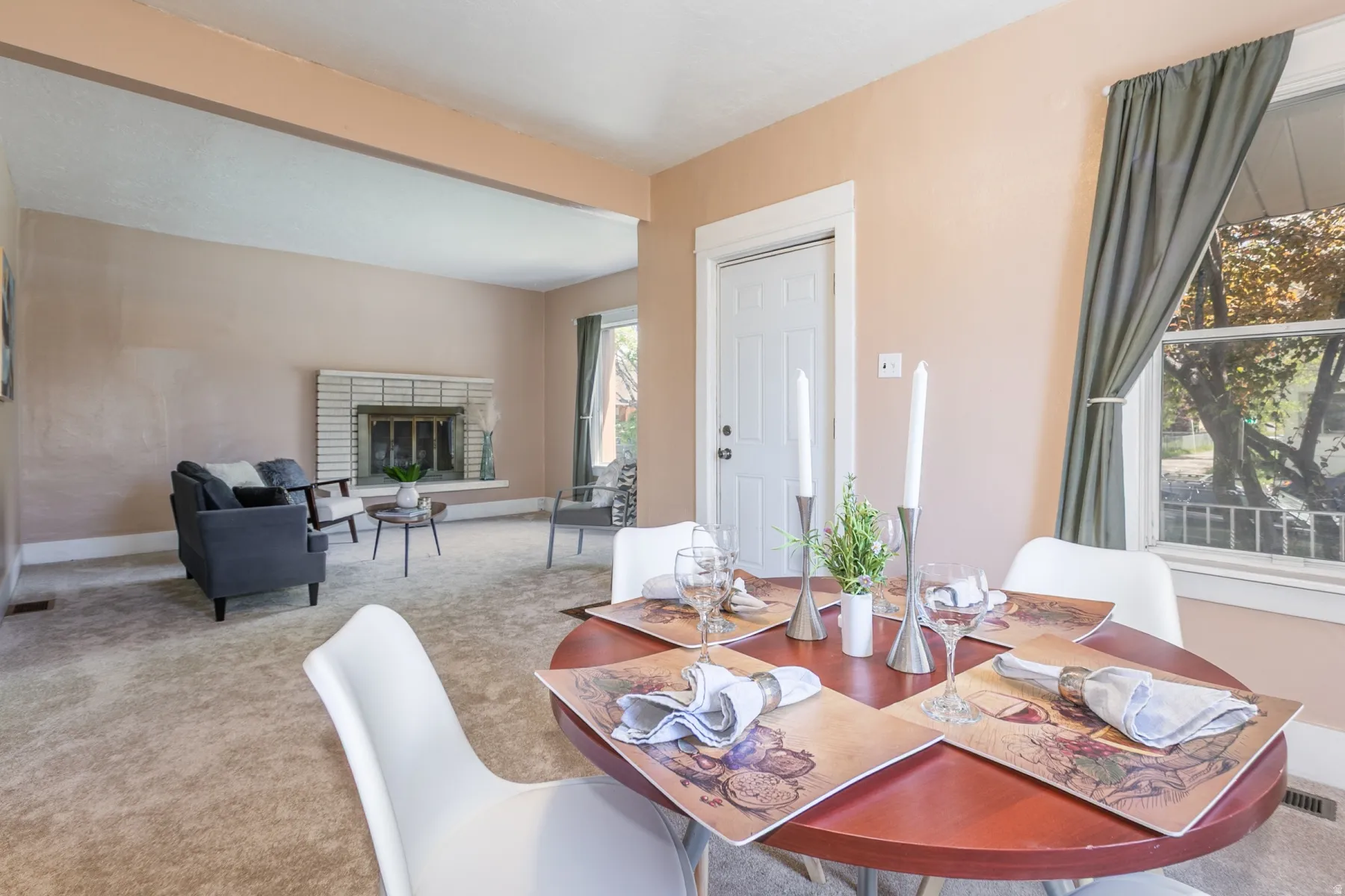 Dining room featuring a fireplace and carpet floors