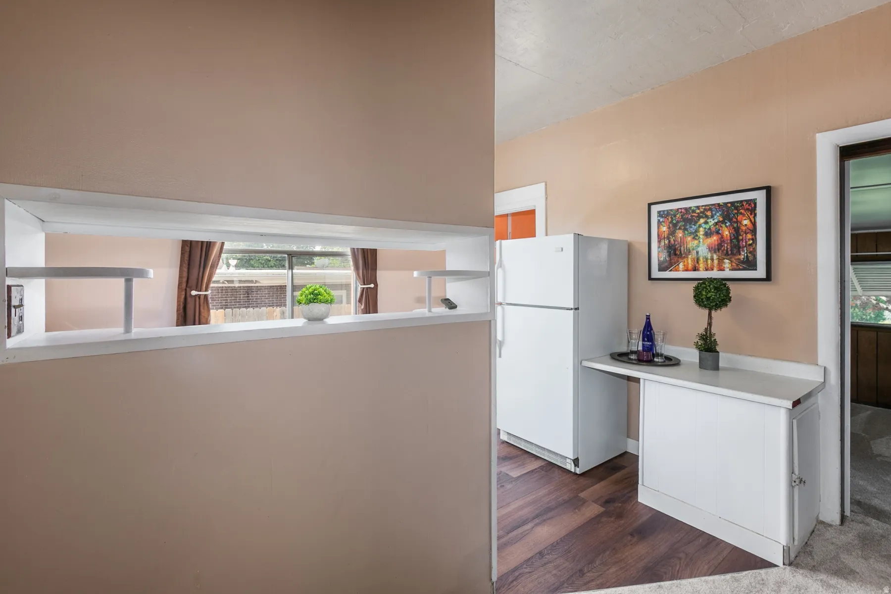 Kitchen featuring freestanding refrigerator, dark wood-style flooring, and light countertops