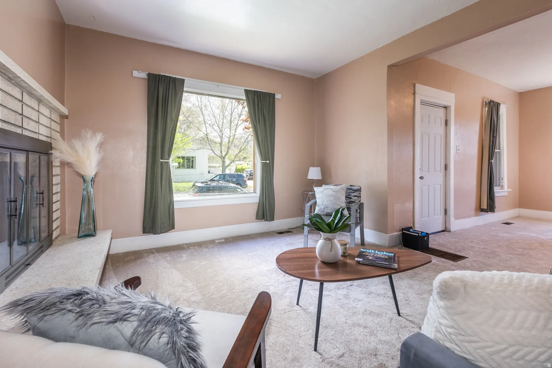 Carpeted living area with baseboards