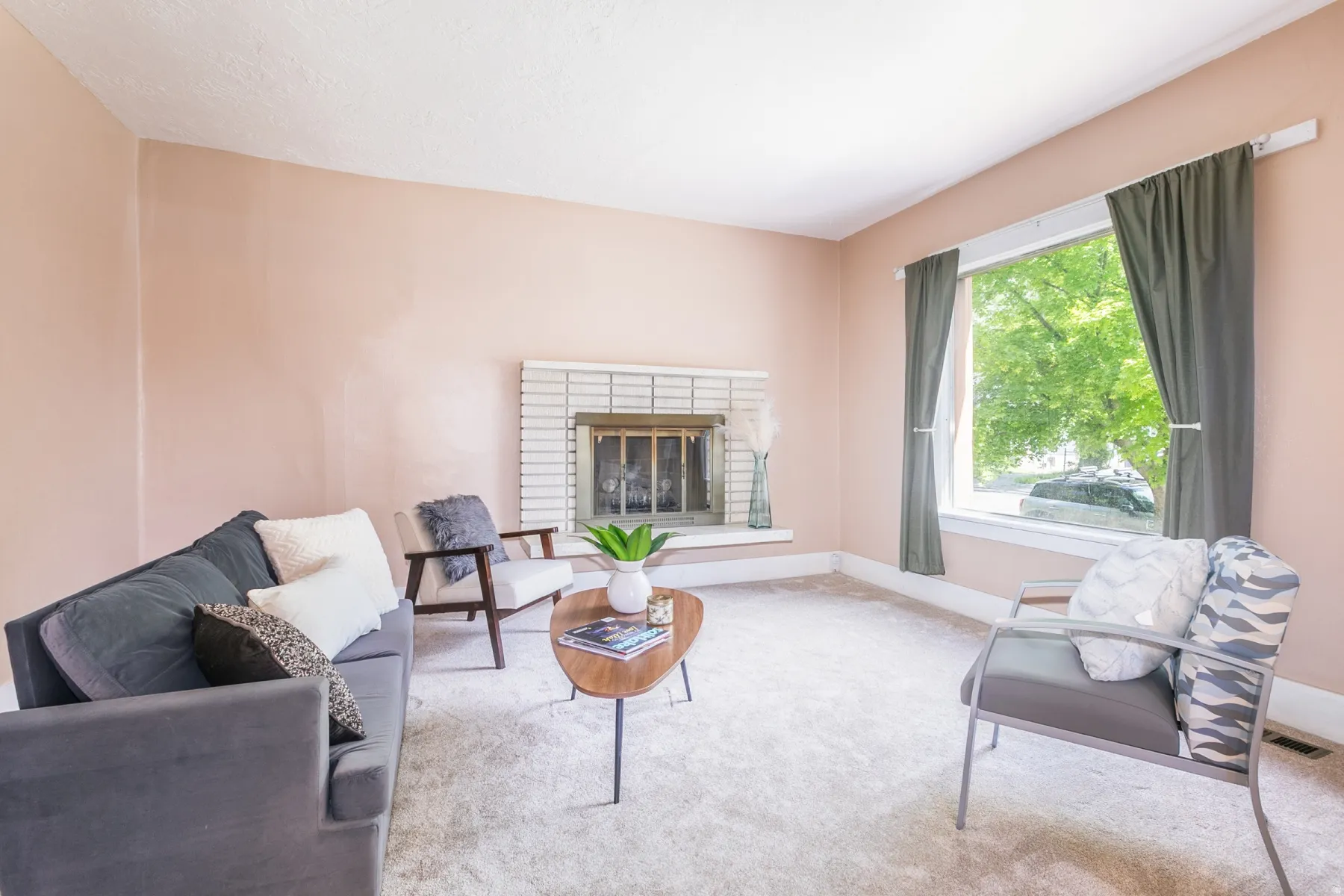 Living area featuring a brick fireplace and carpet floors