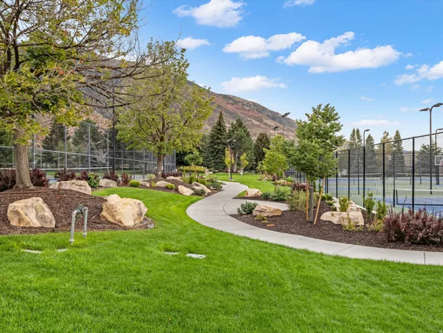 Curved concrete pathway winding through landscaped grounds