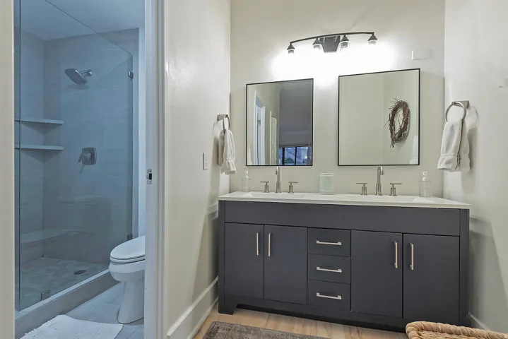Bathroom with double vanity and a shower stall