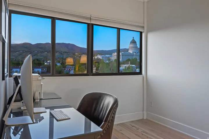 Office space featuring a mountain view and light wood finished floors