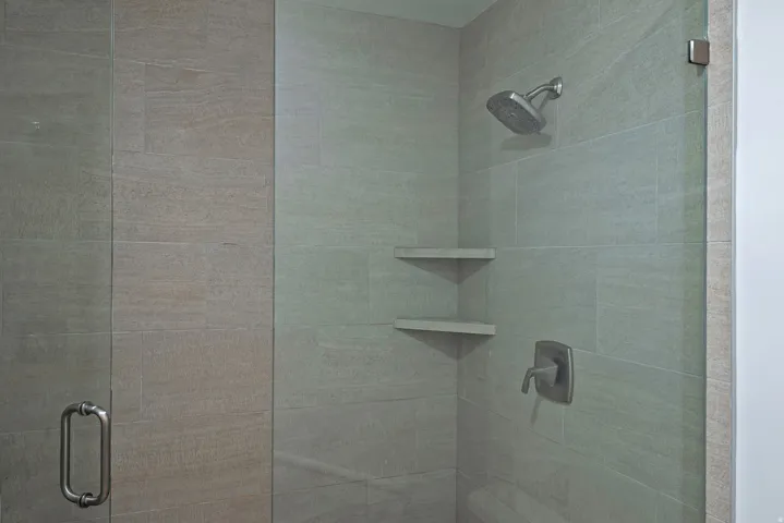 Full bathroom with a shower stall