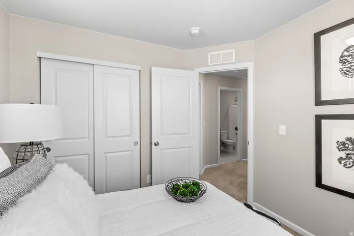 Bedroom with a closet and light carpet