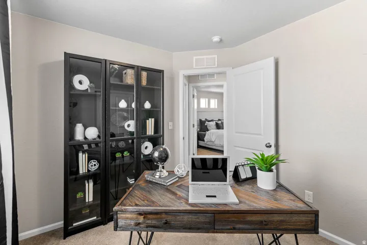 Office area featuring light carpet