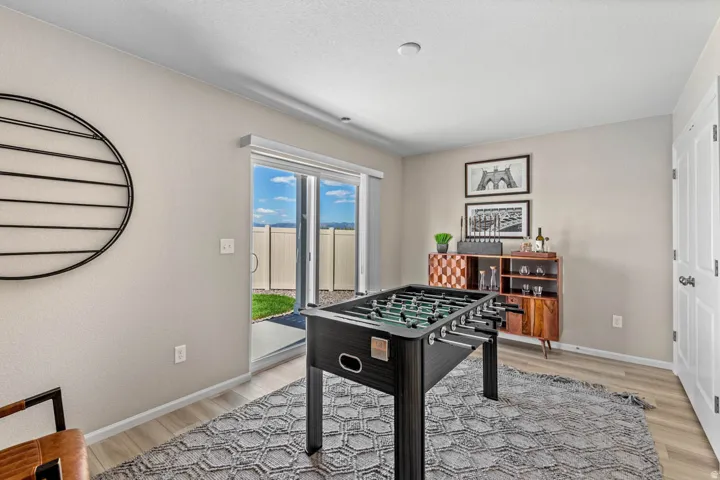 Rec room with light wood-type flooring