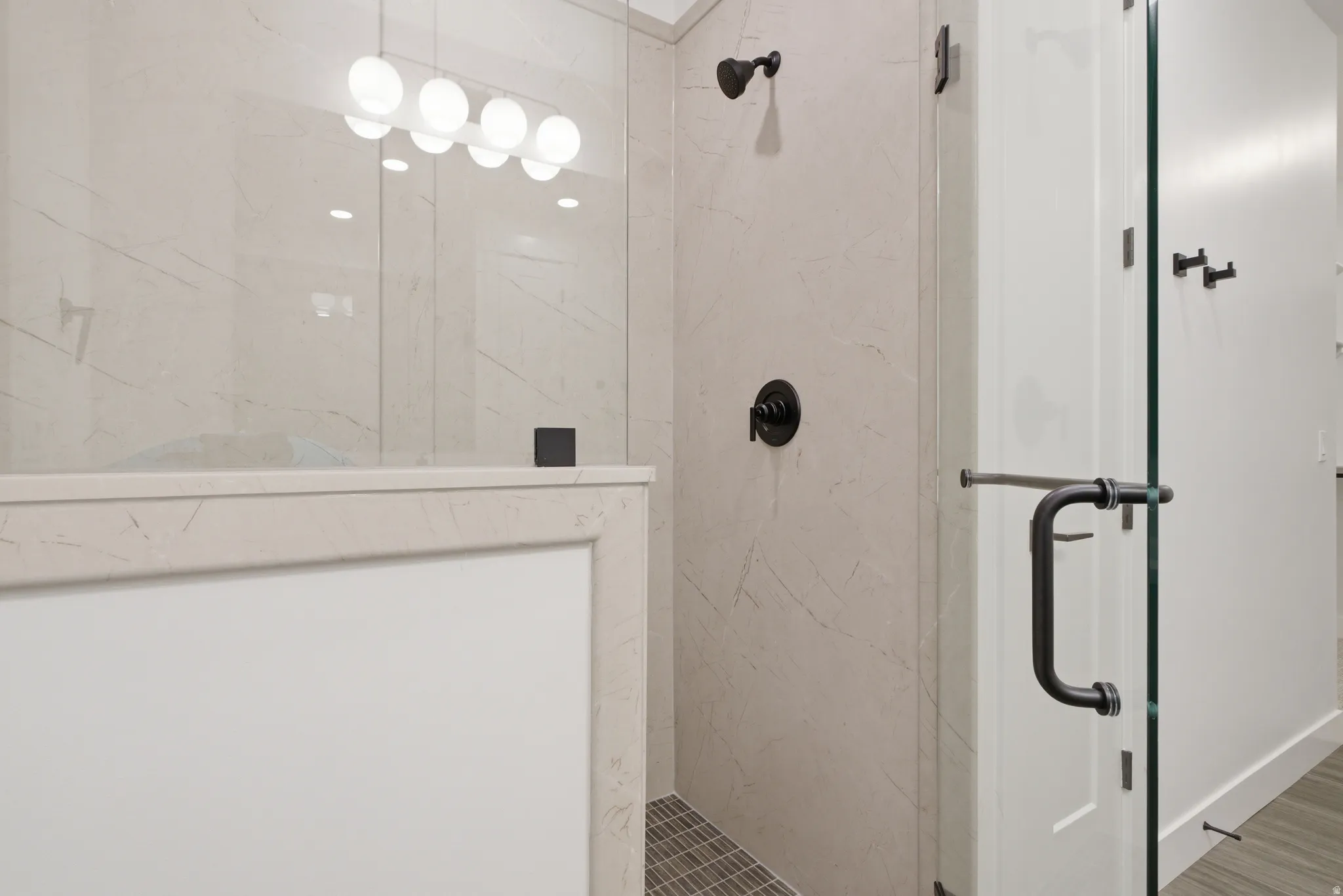 Bathroom featuring a marble finish shower