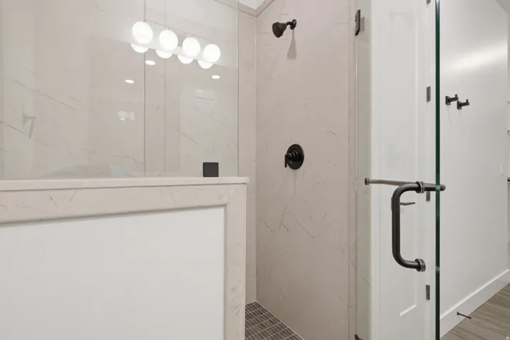 Bathroom featuring a marble finish shower