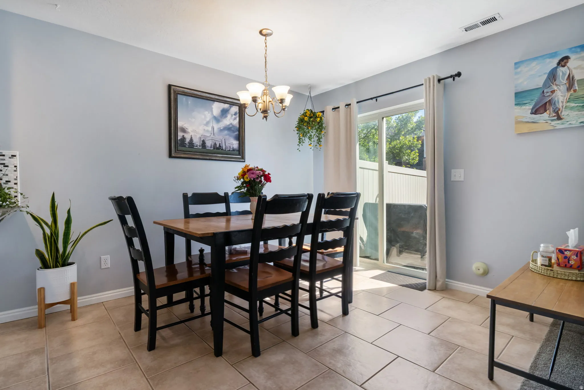 Dining space featuring a chandelier and light tile patterned floors