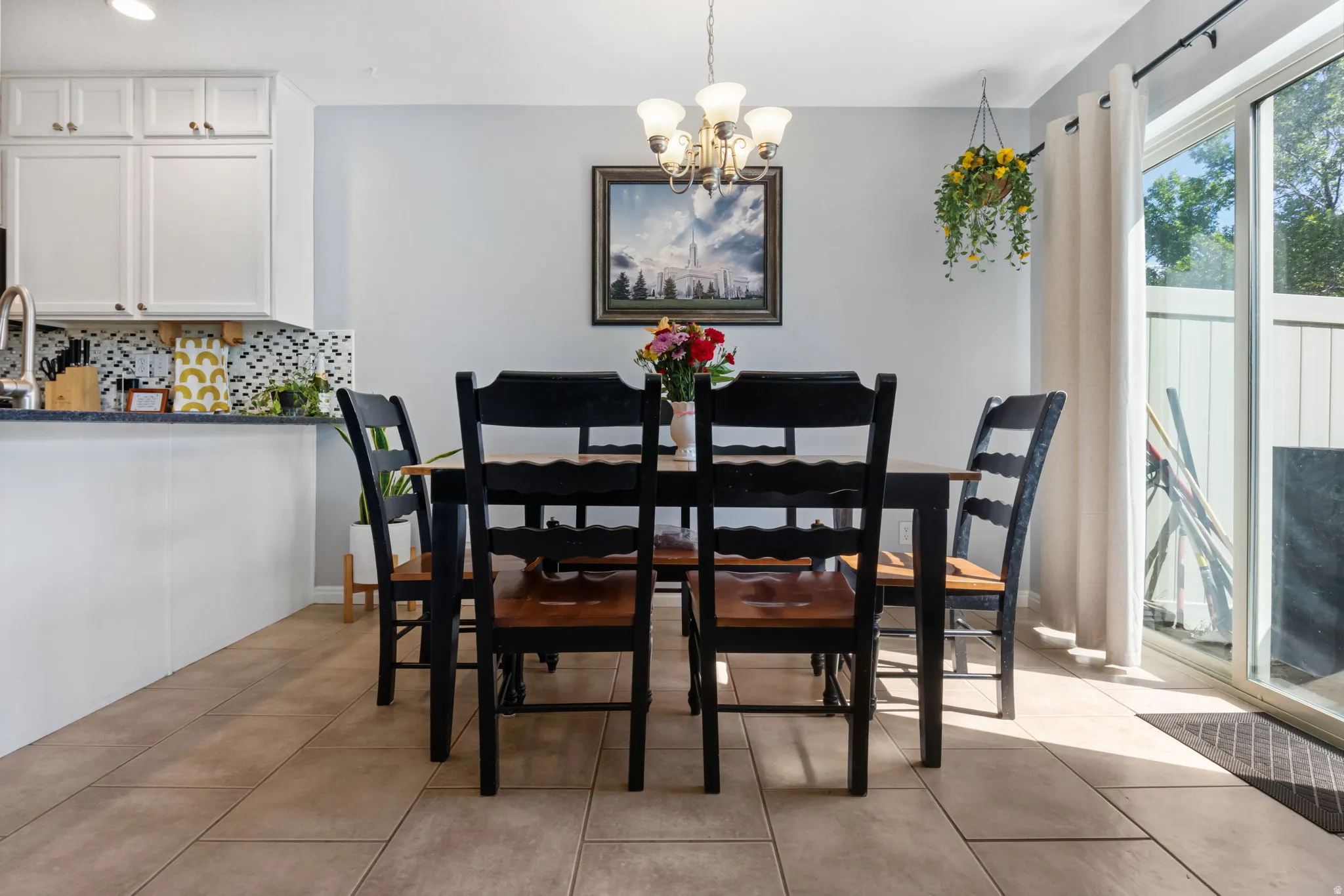 Dining area featuring a chandelier and light tile patterned flooring