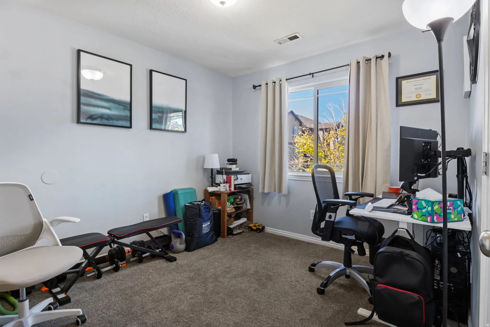 Office space featuring dark carpet and baseboards