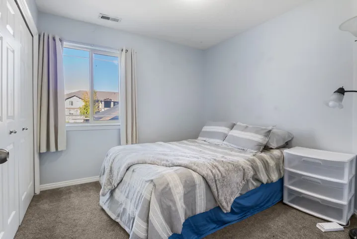 Bedroom featuring a closet and carpet flooring