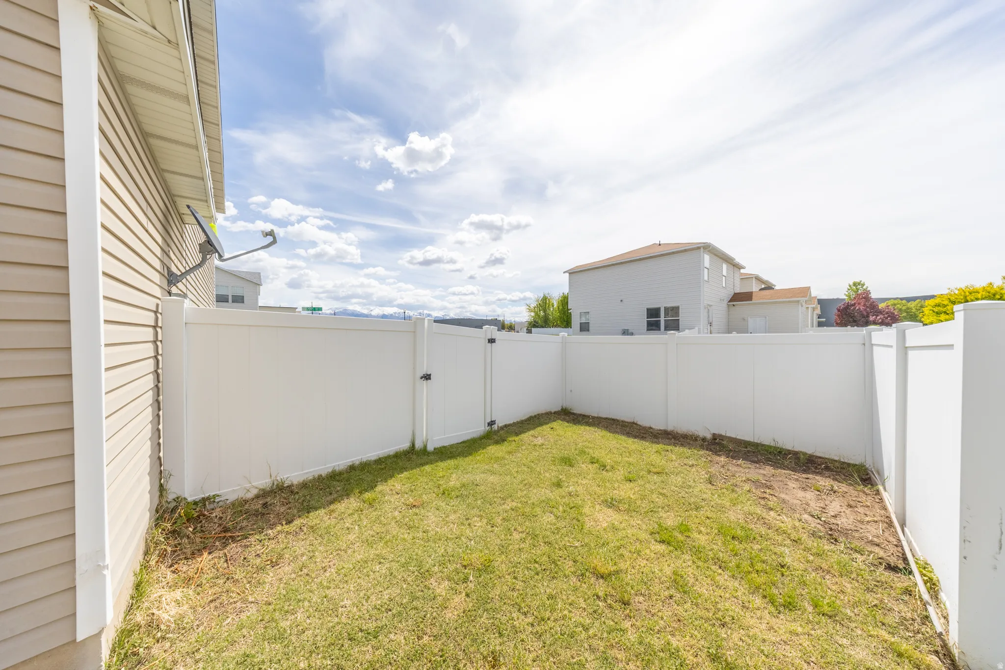 Fenced backyard with a gate