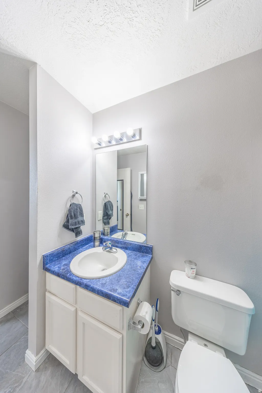 Half bathroom featuring toilet and vanity