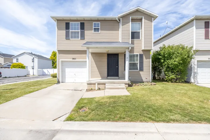 Traditional home with an attached garage and driveway