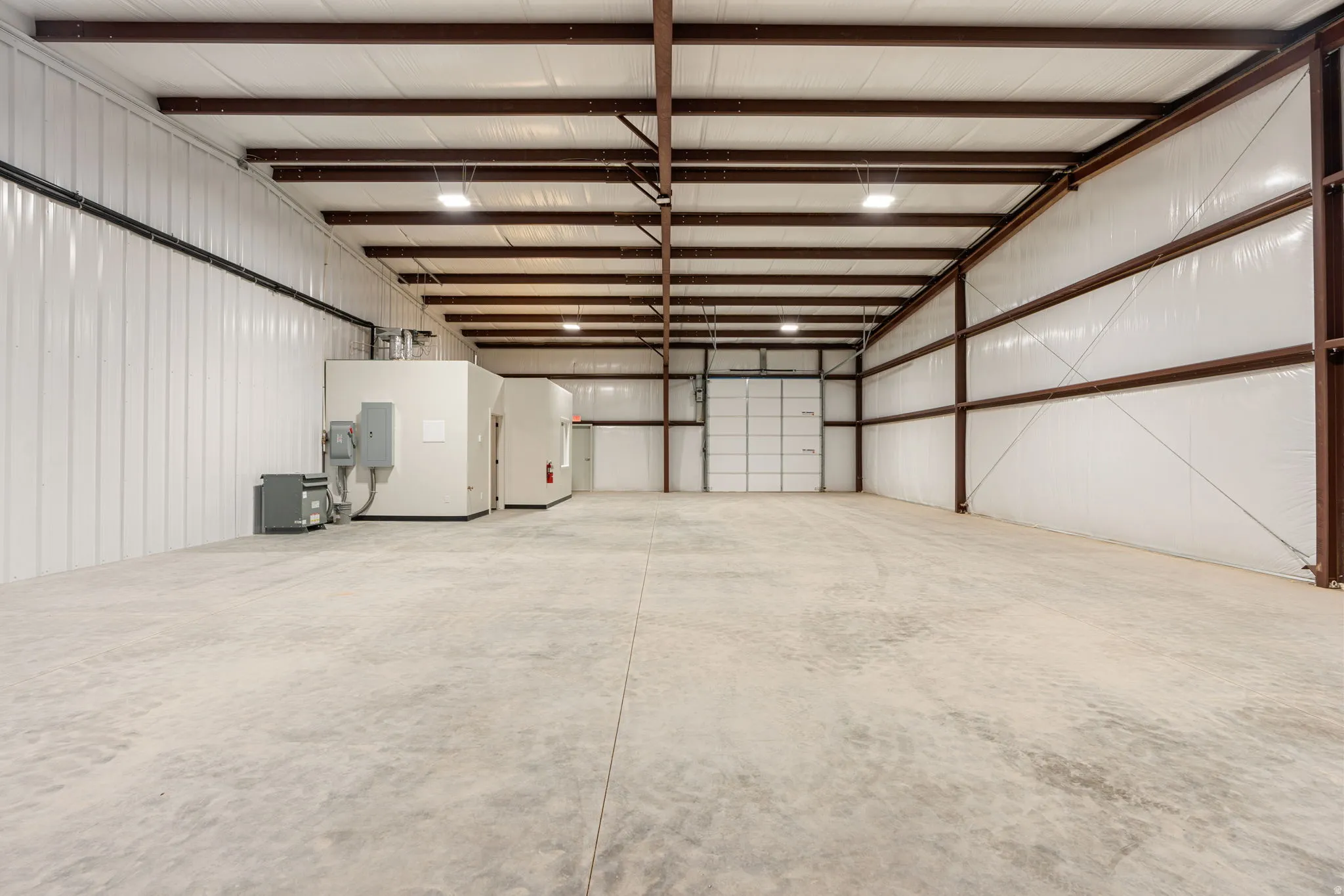 Garage featuring metal wall and electric panel