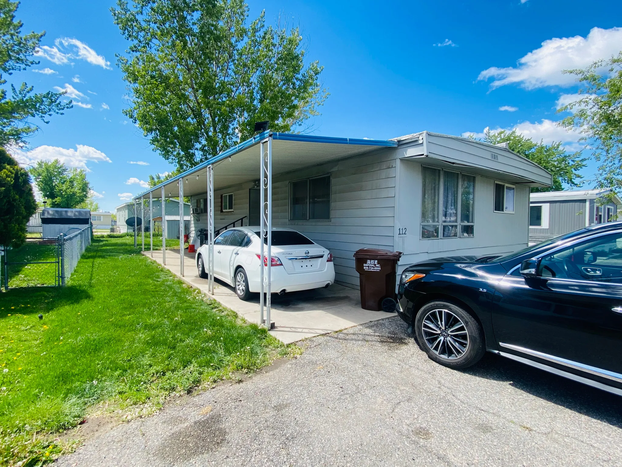 View of home's exterior with an attached carport and driveway
