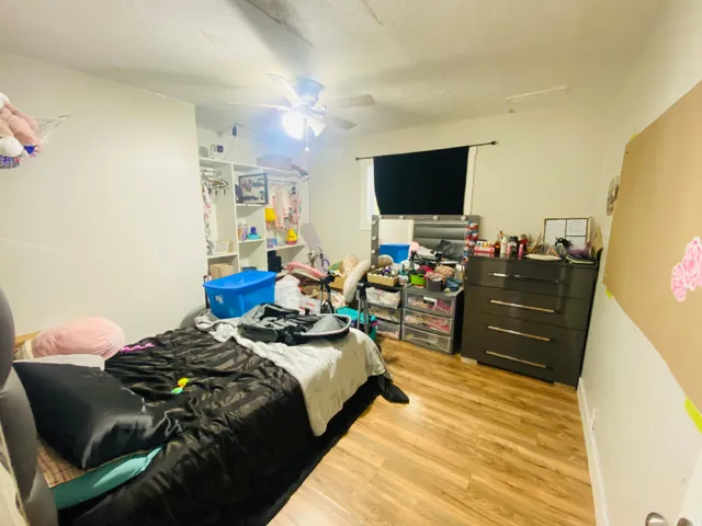 Bedroom featuring light wood-style floors and a ceiling fan