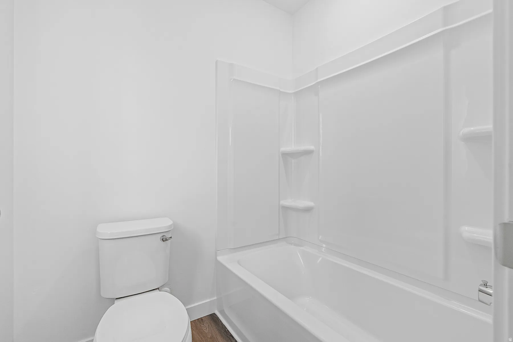 Full bath featuring bathing tub / shower combination and dark wood-style flooring