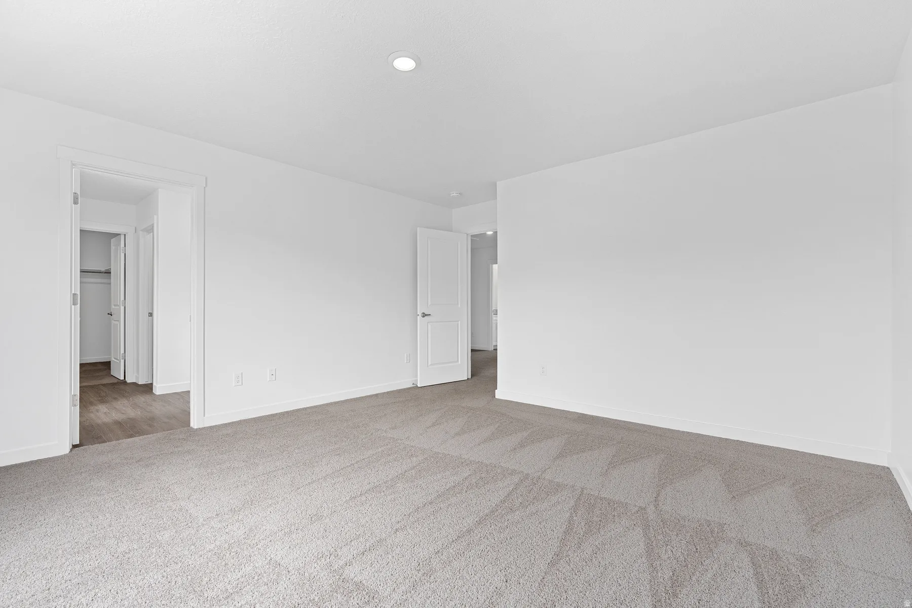 Unfurnished room featuring baseboards and light colored carpet