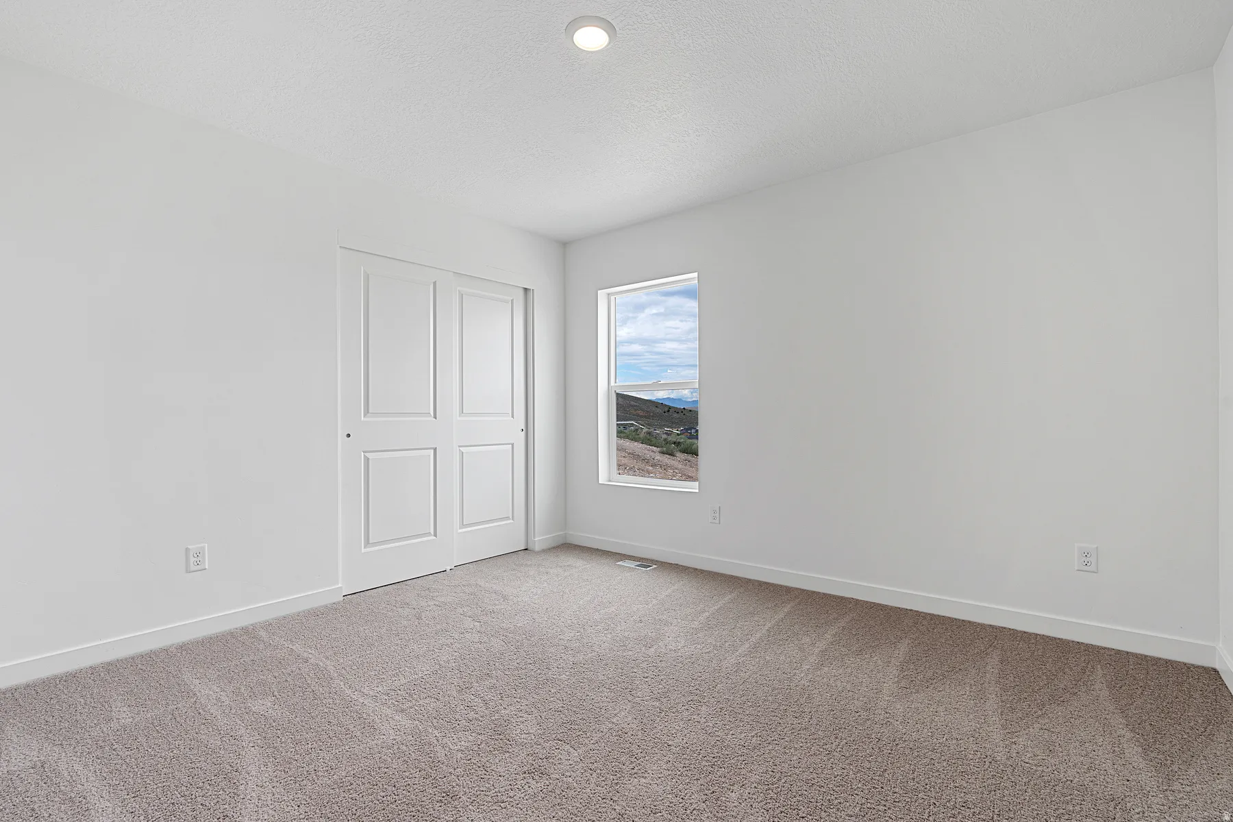 Unfurnished bedroom with carpet flooring, a closet, and a textured ceiling