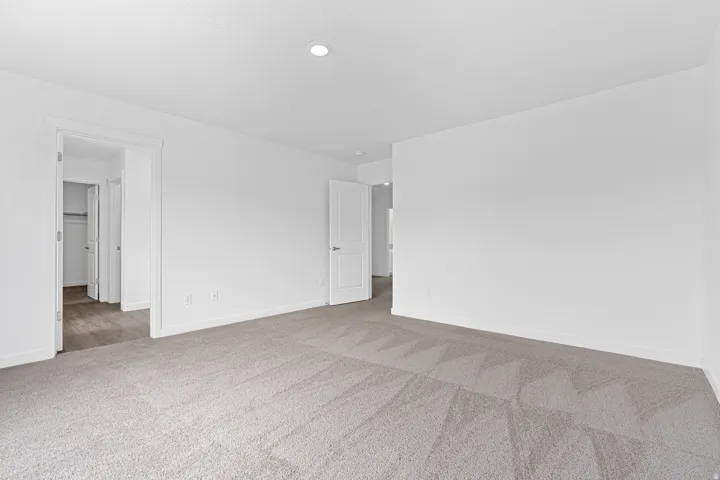 Unfurnished room featuring baseboards and light colored carpet