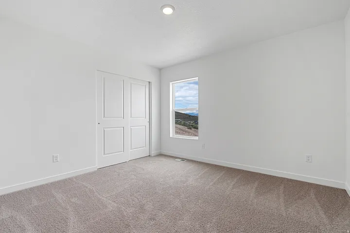 Unfurnished bedroom with carpet flooring, a closet, and a textured ceiling