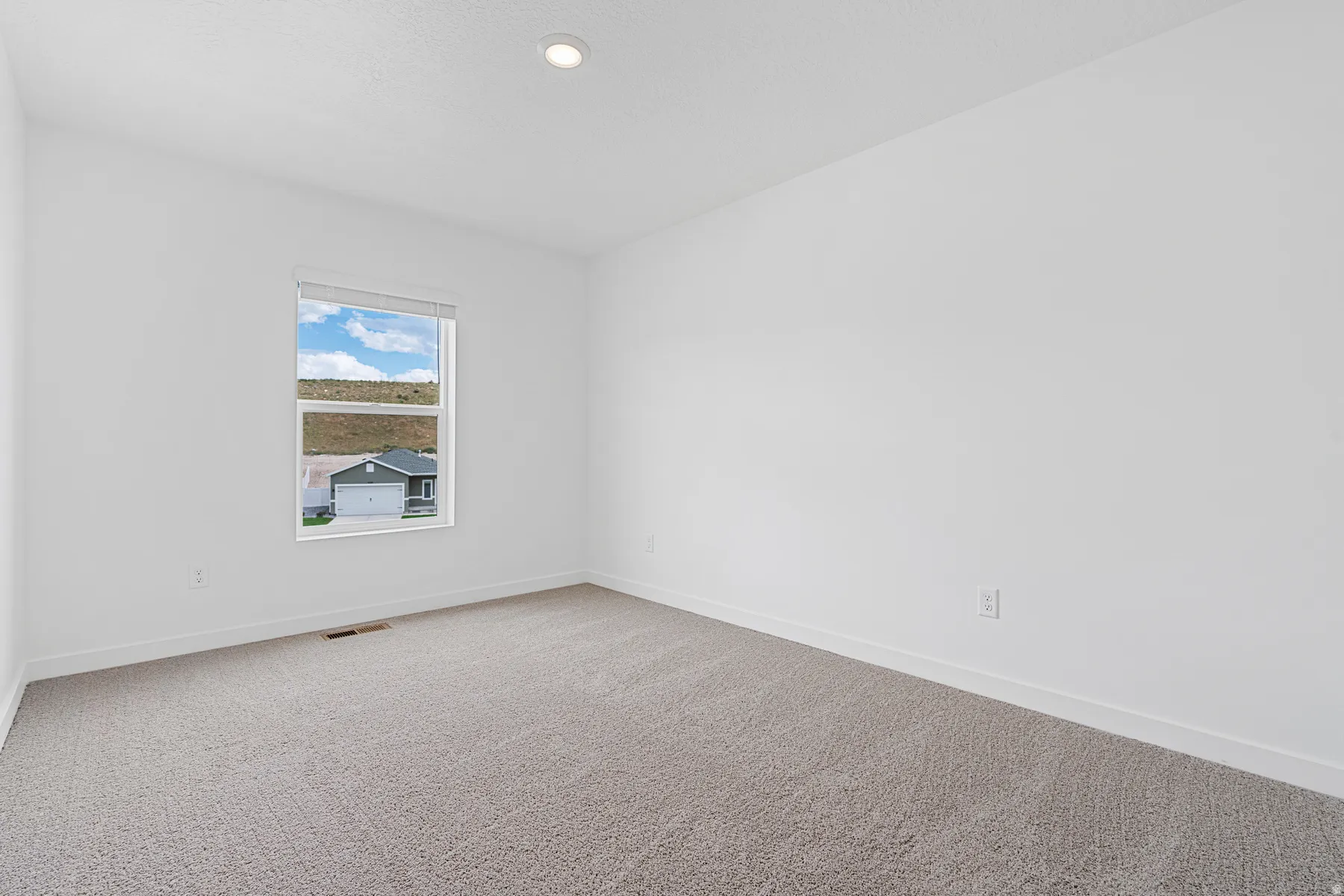 Unfurnished room featuring baseboards and light colored carpet